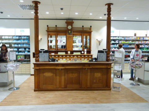 Antike Kassentheke aus Holz in der SaniPEP Apotheke